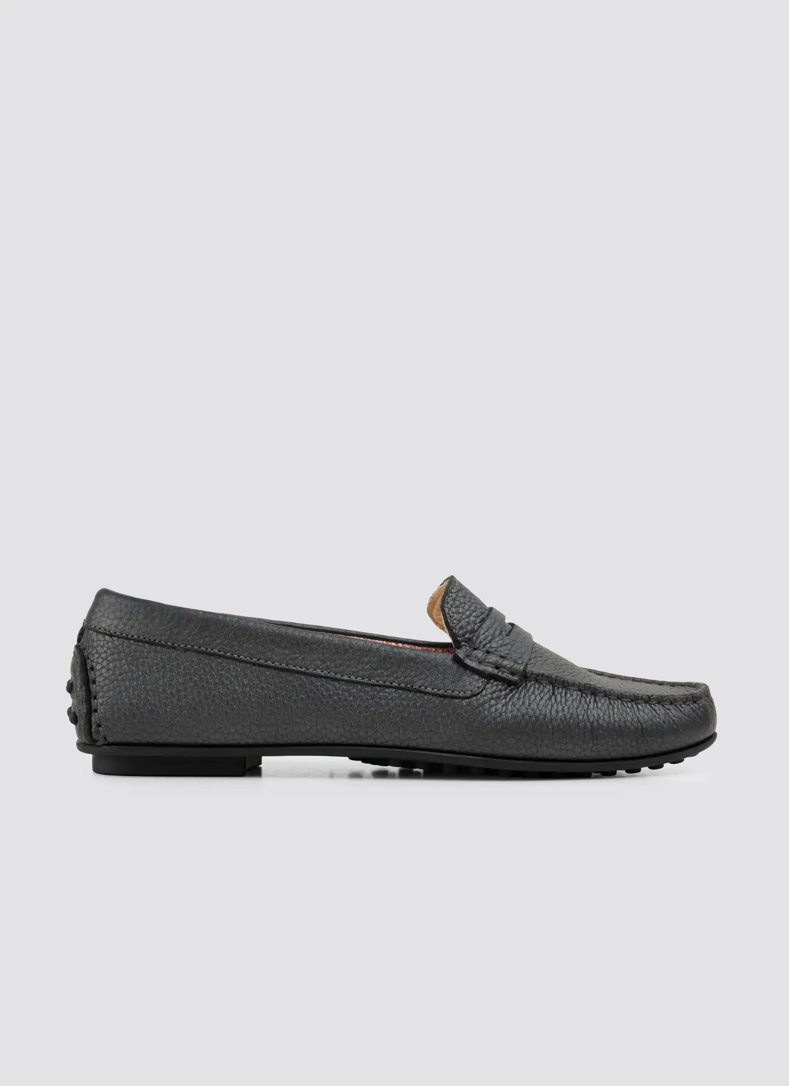 Black loafer shoe on a light gray background 