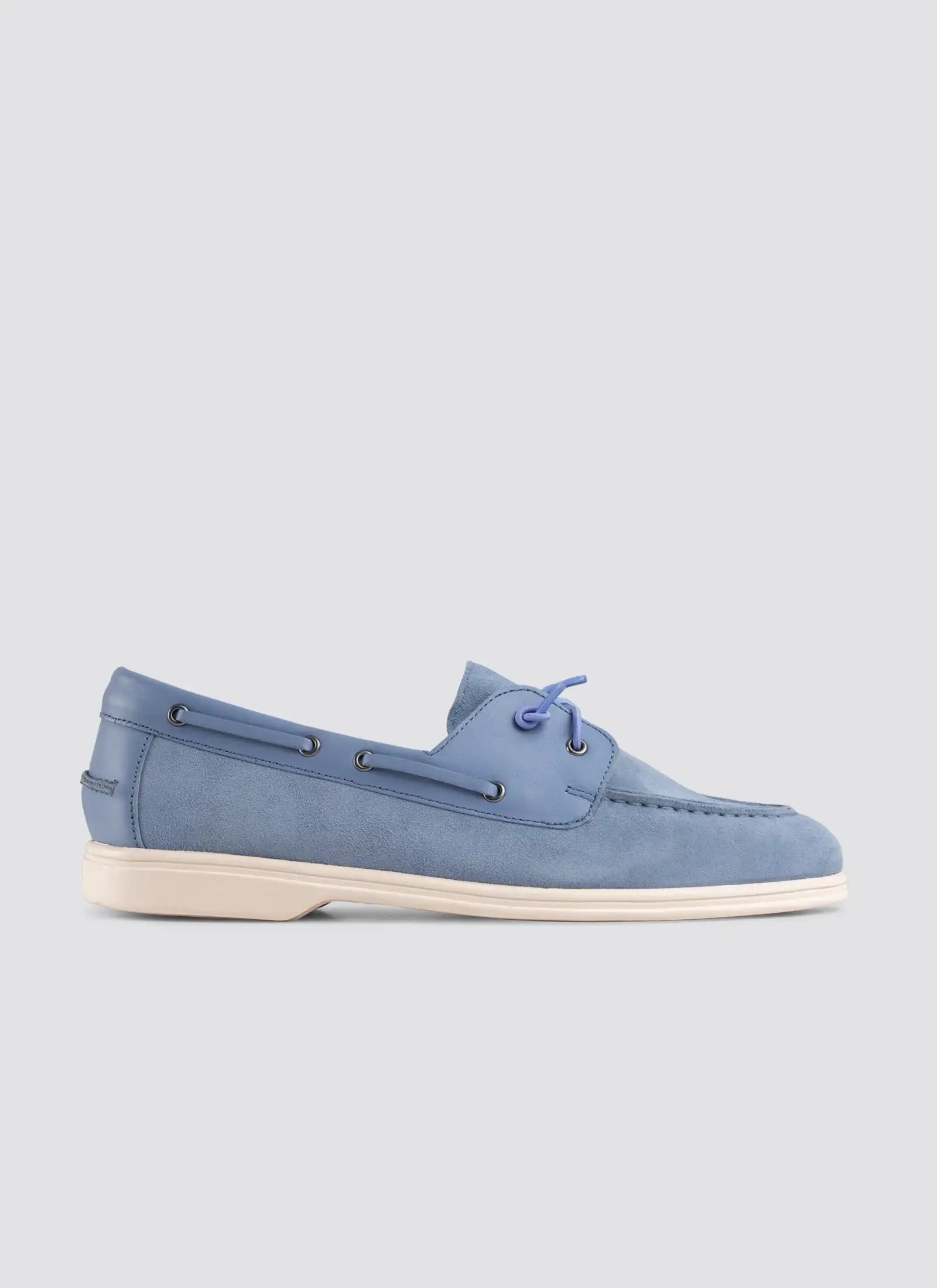 Blue suede shoe on a light gray background 