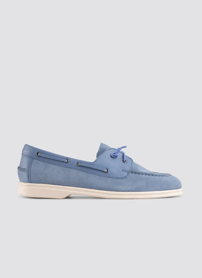 Blue suede shoe on a light gray background 