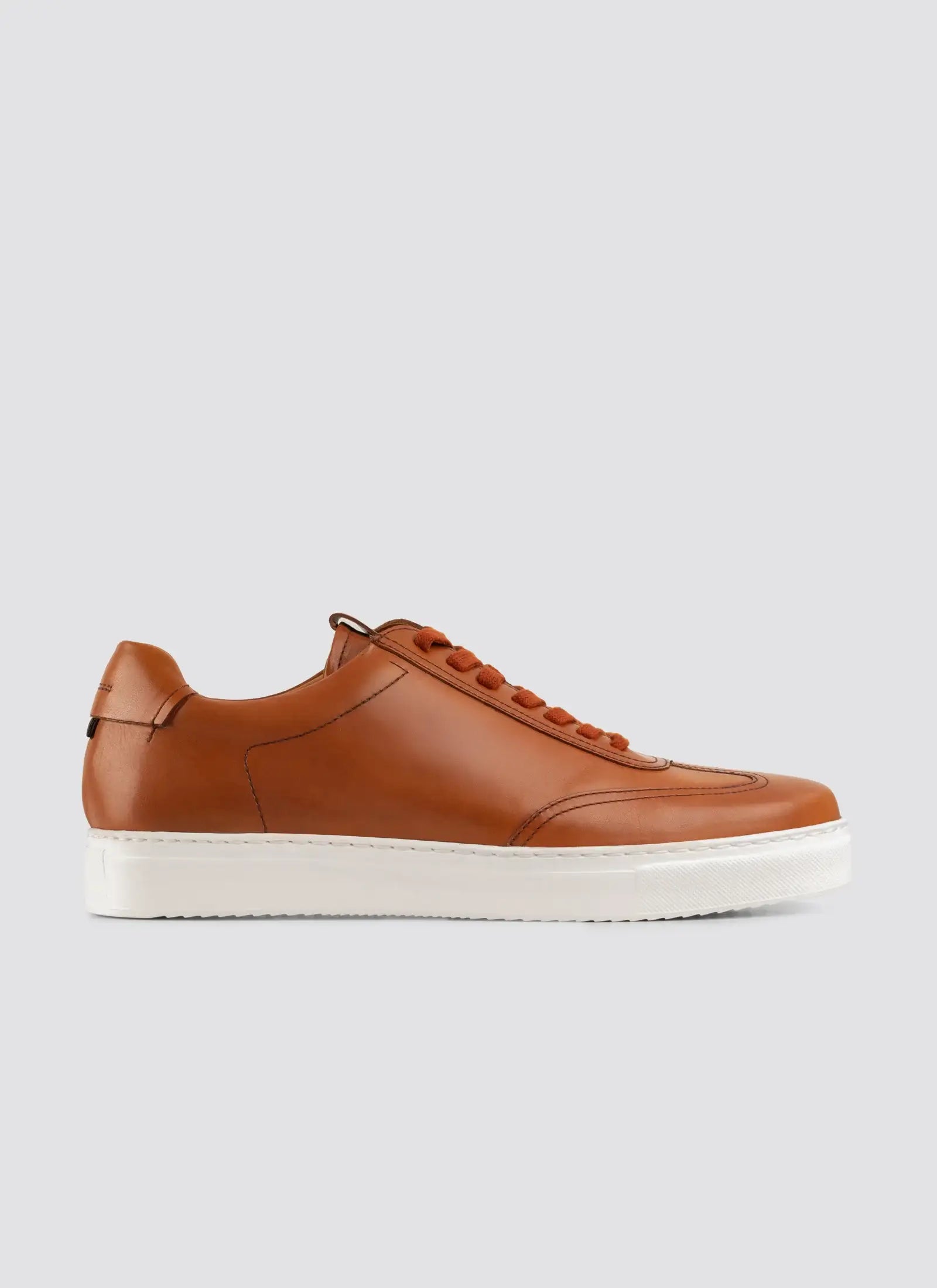 Brown leather sneaker with white sole, men's casual footwear on plain background 
