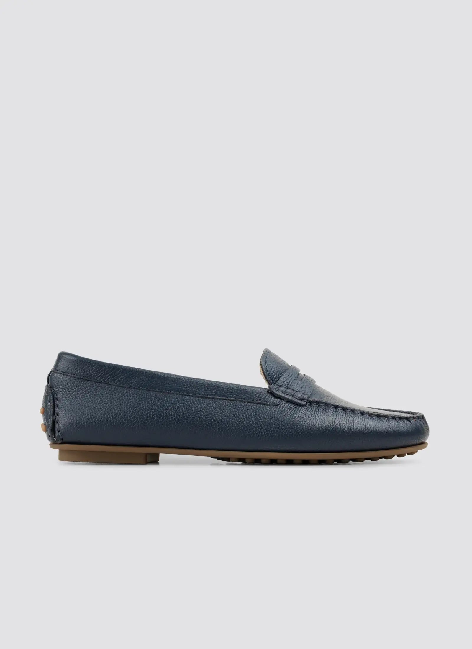 Black flat shoe with a strap on a white background 