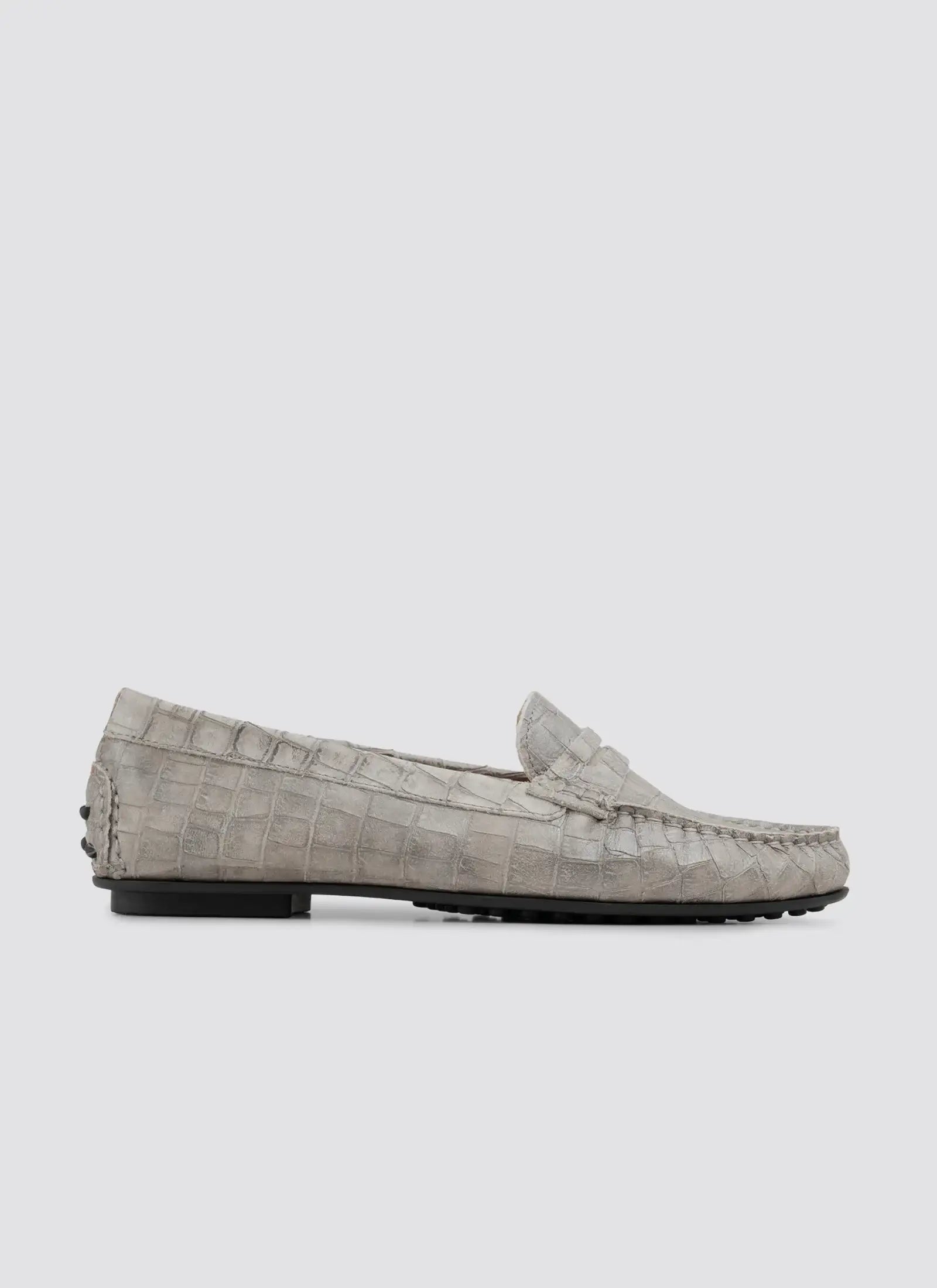 Gray loafers with a textured pattern on a white background 