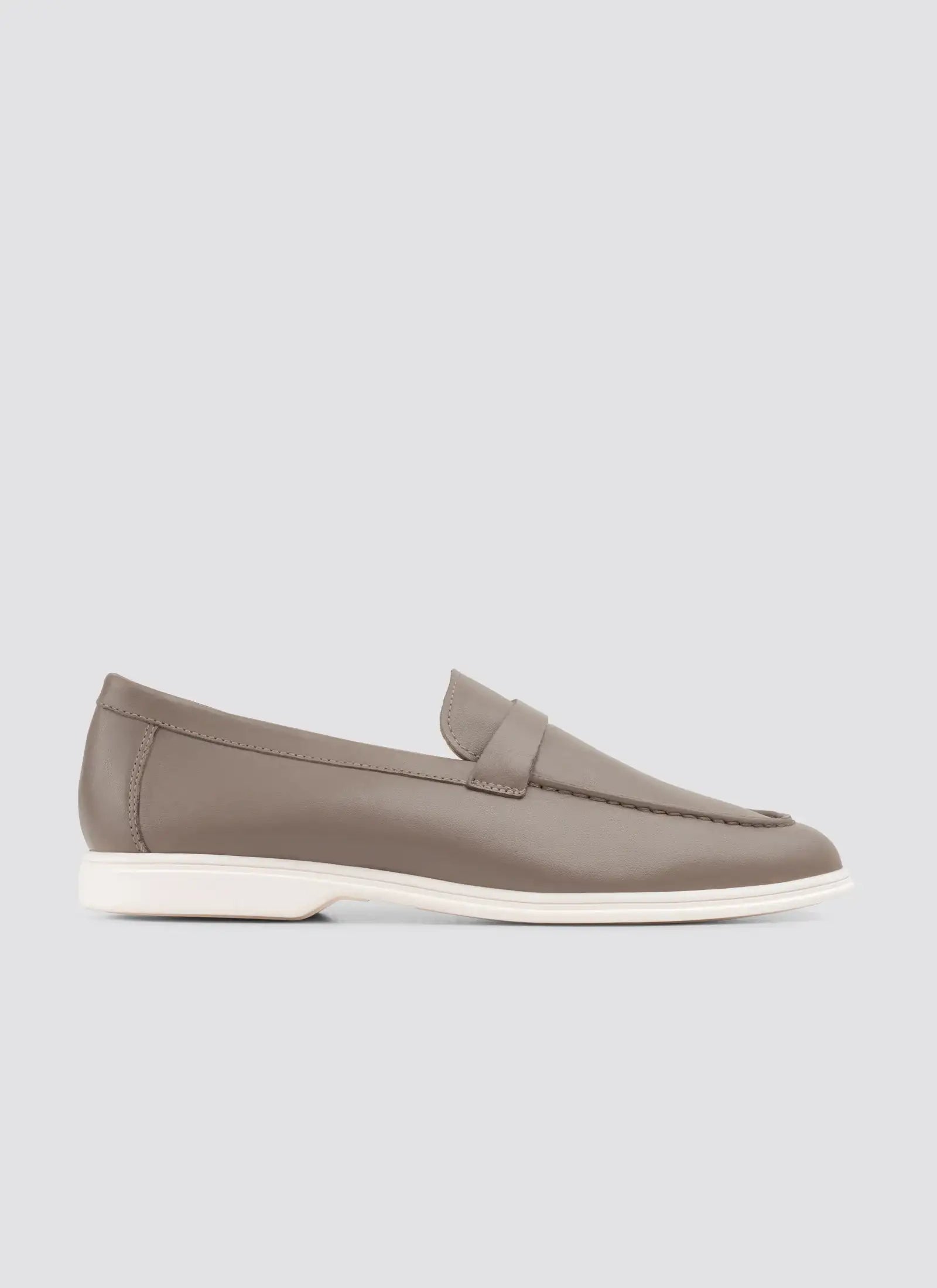Taupe loafer shoe on a light gray background 