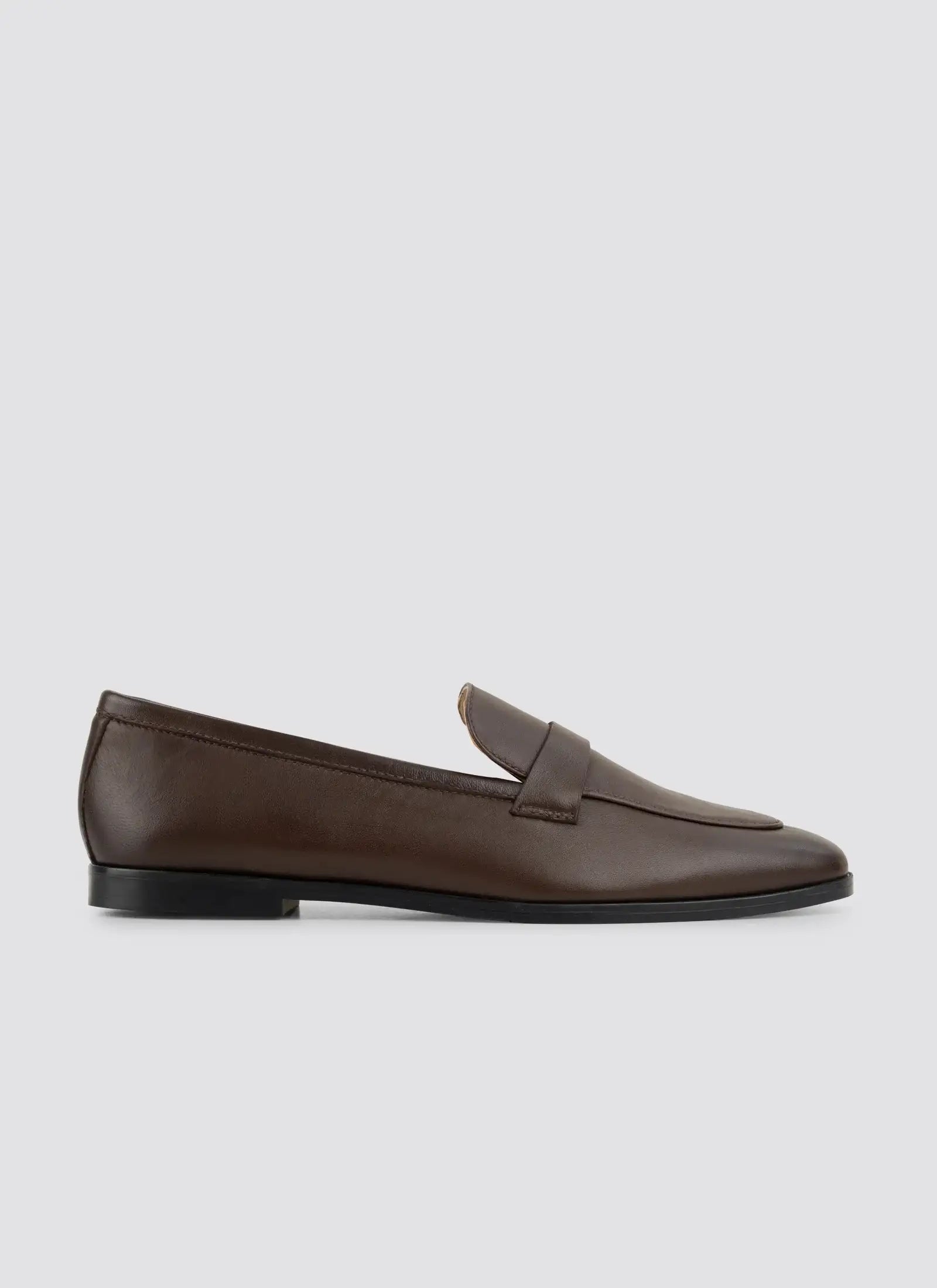 Brown loafer shoe on a light gray background 