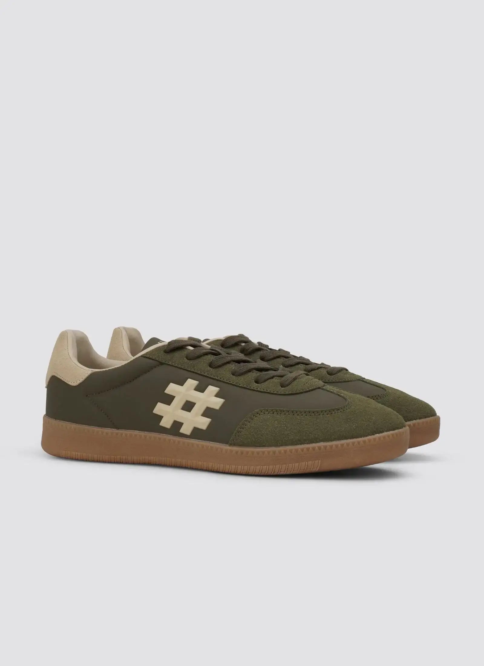 Olive green men's sneakers with beige sole and hashtag symbol, side view on white background. 