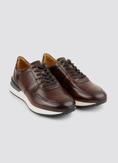 Pair of brown leather men's sneakers with white soles on a neutral background  