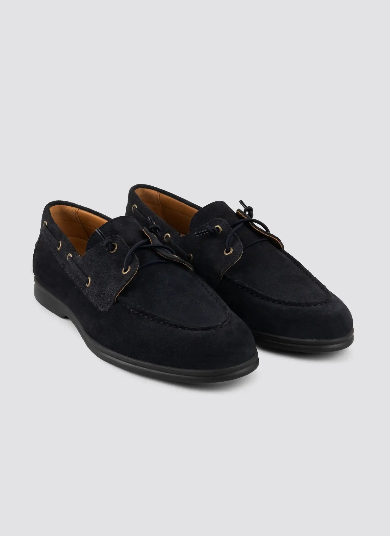 Men's black suede lace-up loafers with contrast stitching and rubber soles on white background 