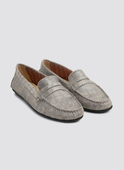 Pair of gray loafers on a light gray background 