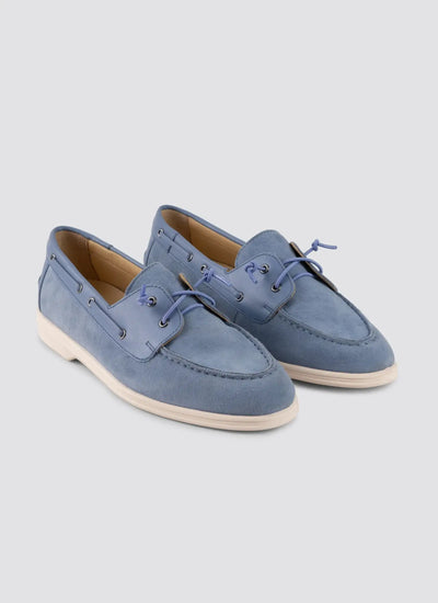 Pair of blue suede shoes on a light gray background 