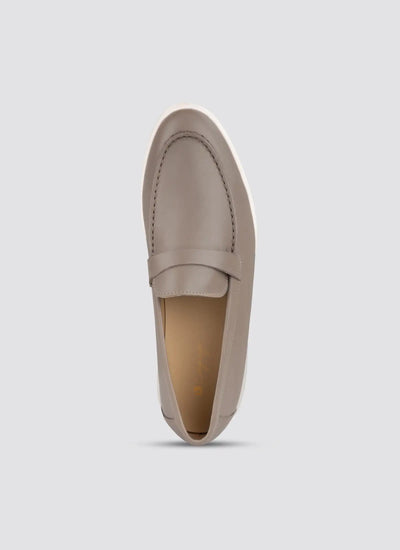 Beige loafer shoe on a light gray background 