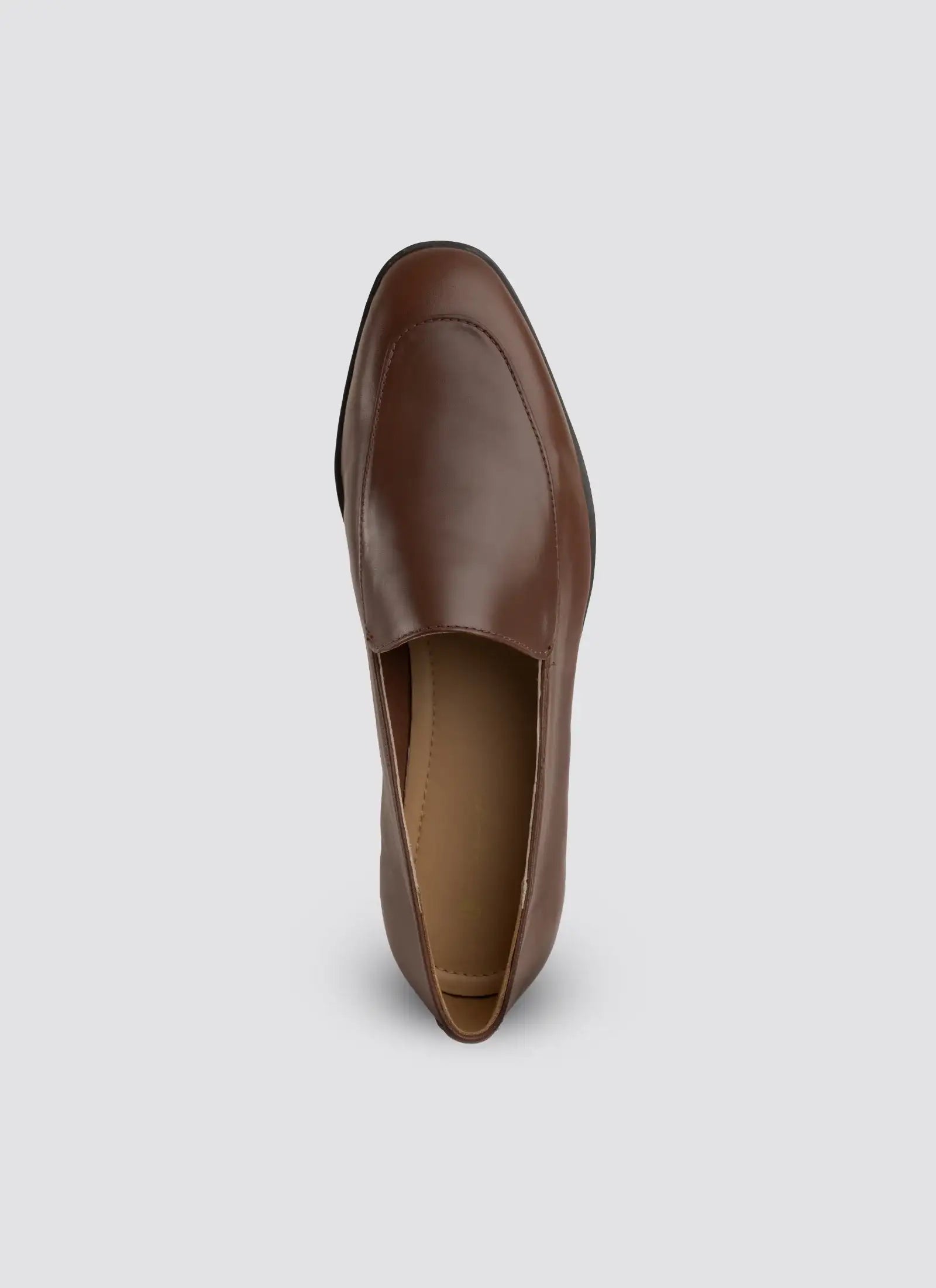 Brown leather loafer on a light gray background  