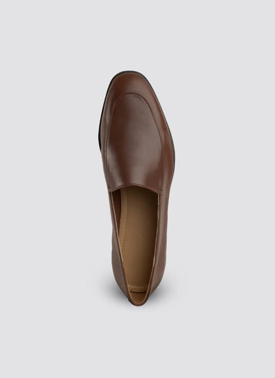 Brown leather loafer on a light gray background  