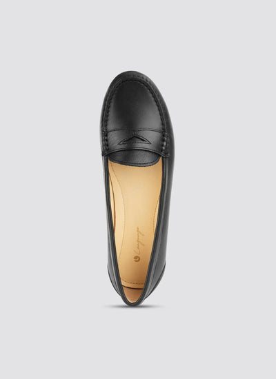 Black loafer shoe on a light gray background 