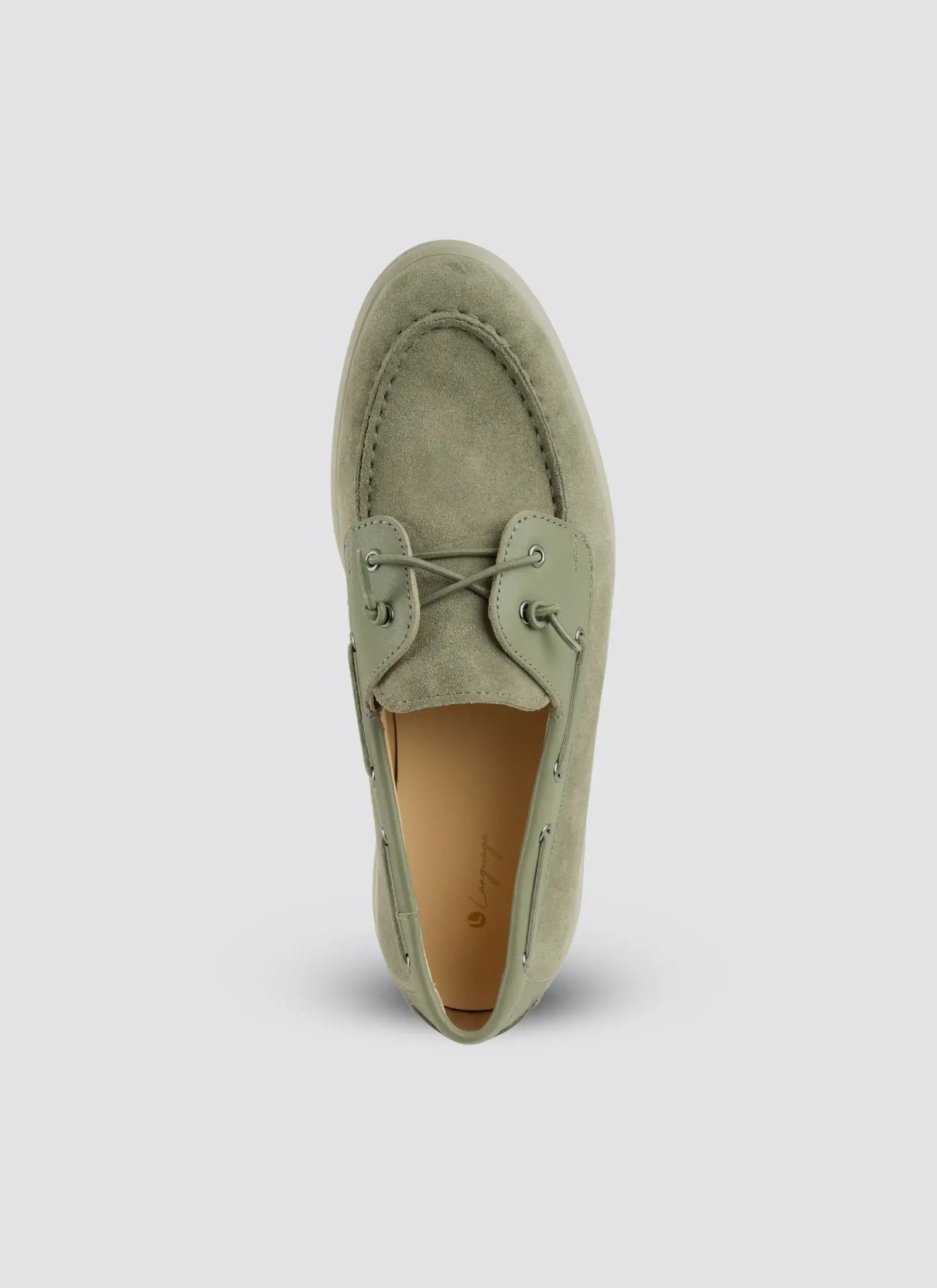 Green suede loafer shoe on a light gray background 