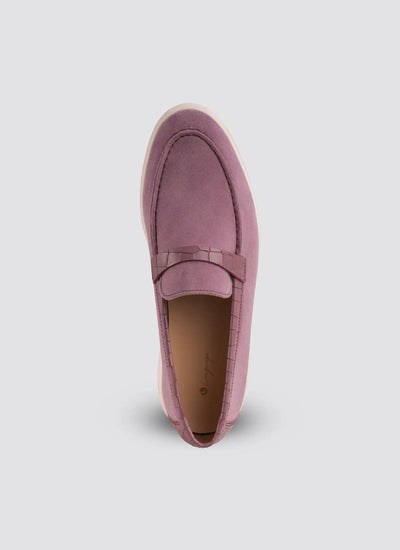 Pink loafer shoe on a light gray background 