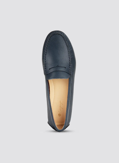 Navy blue loafer shoe on a light gray background  