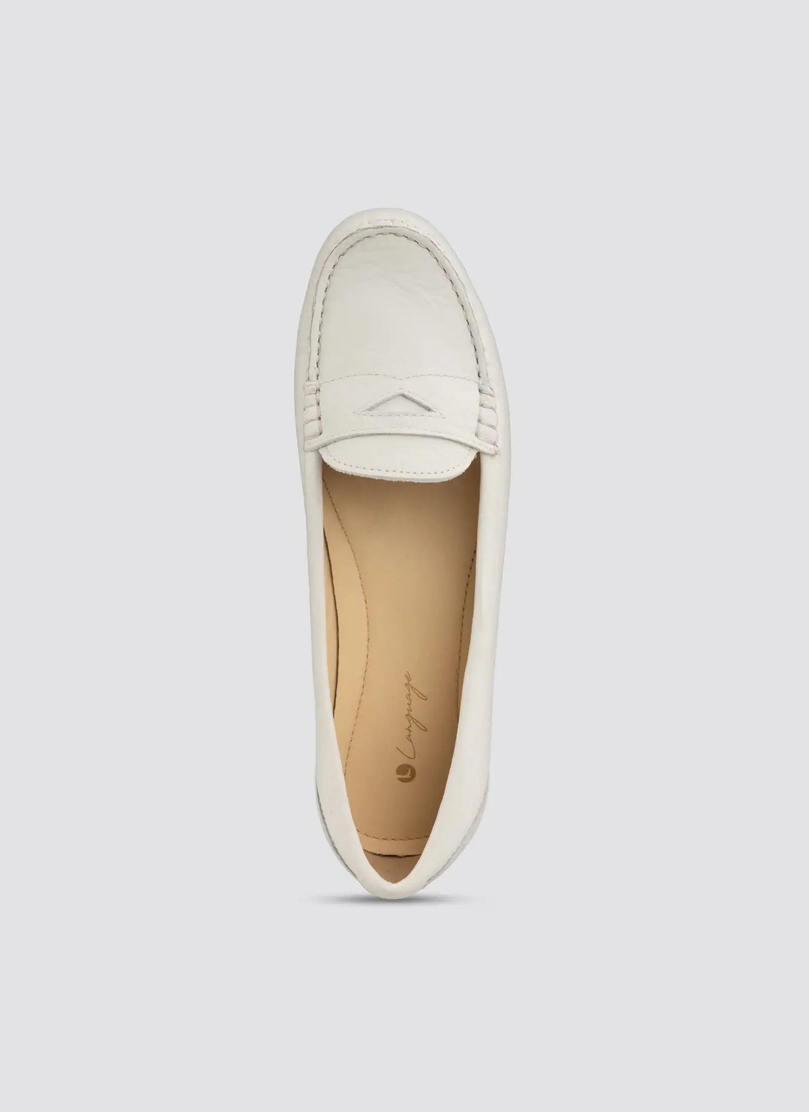 White loafer shoe on a light gray background 