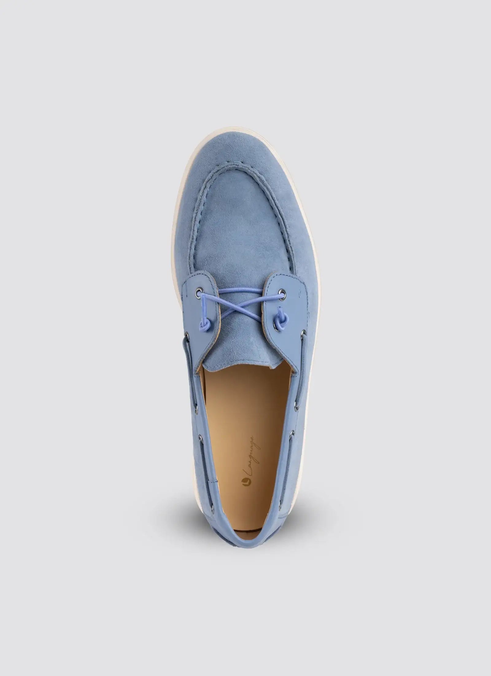 Light blue suede shoe on a light gray background 